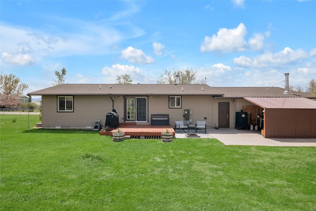 back of house with a wooden deck, a patio, and a shingled roof