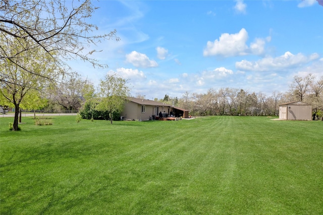 view of grassy yard featuring an outbuilding and a shed