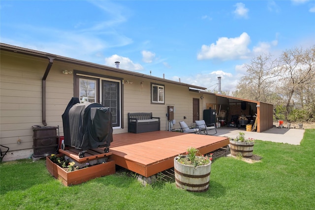 rear view of property featuring a wooden deck and a lawn