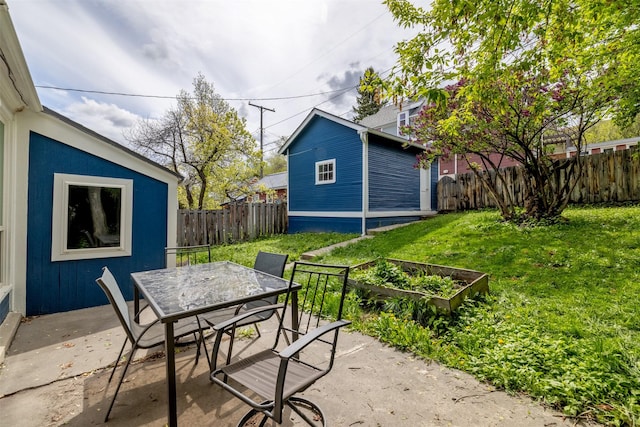 view of patio featuring a vegetable garden and outdoor dining space