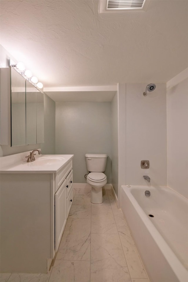 full bathroom featuring marble finish flooring, vanity, toilet, shower / bath combination, and baseboards