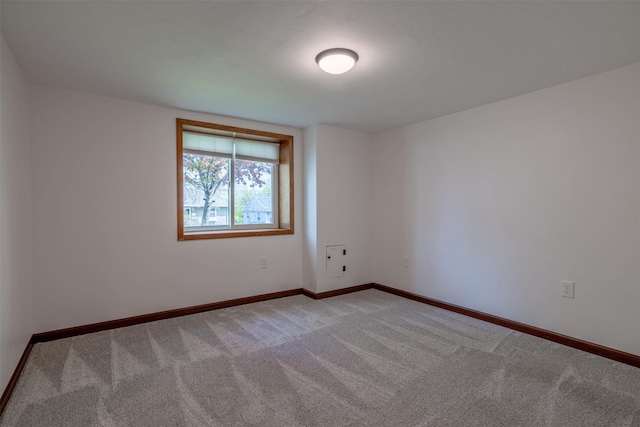 carpeted empty room with baseboards