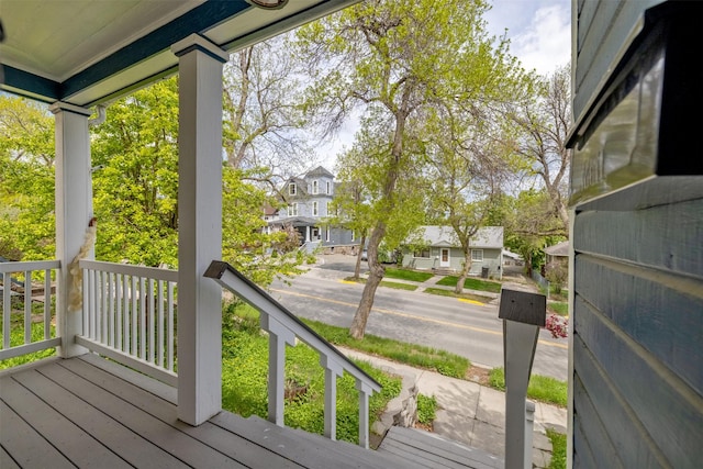 deck featuring a residential view and a porch
