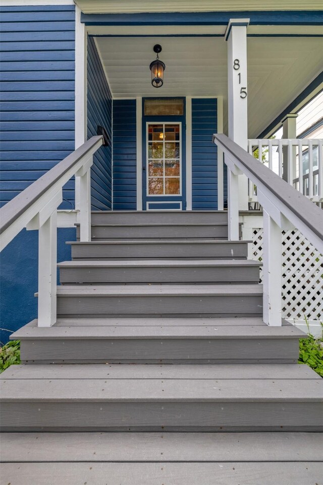 view of exterior entry with a porch