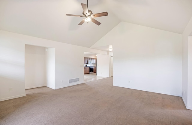 empty room featuring ceiling fan, light carpet, high vaulted ceiling, and baseboards