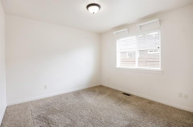 empty room with carpet flooring and baseboards