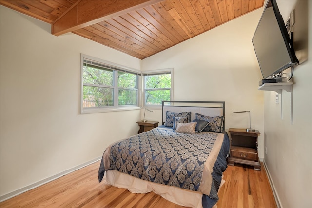 bedroom with lofted ceiling, baseboards, wooden ceiling, and wood finished floors