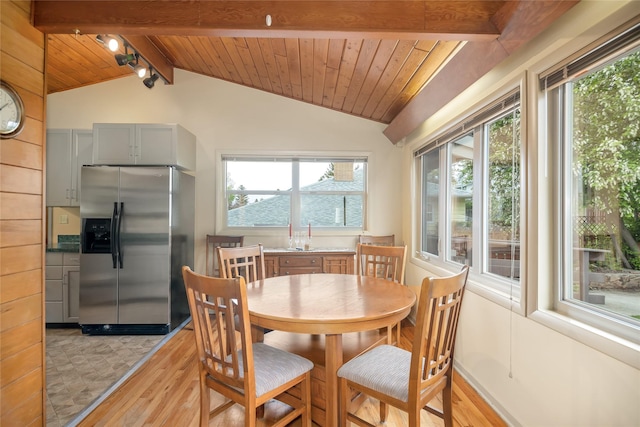dining space featuring light wood-type flooring, plenty of natural light, and wood ceiling