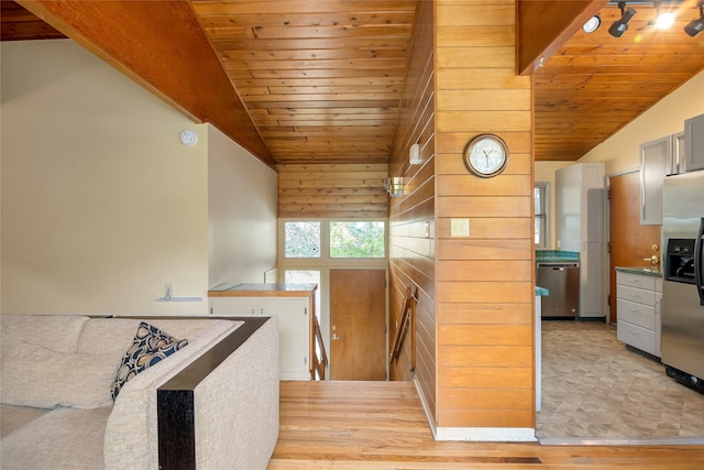 stairs with lofted ceiling, wooden ceiling, and wood finished floors