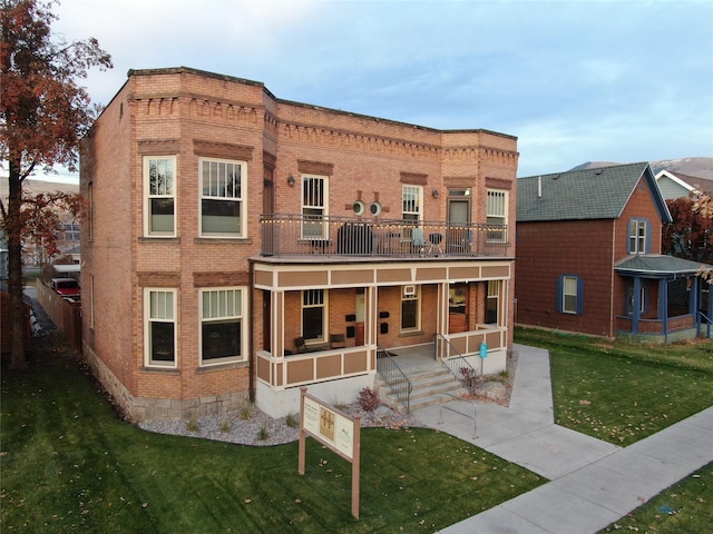 432 W Spruce St Unit 202, Missoula, MT 59802 - back of property with brick siding, a yard, covered porch, and a balcony