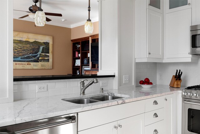 432 W Spruce St Unit 202, Missoula, MT 59802 - kitchen featuring appliances with stainless steel finishes, a sink, tasteful backsplash, ceiling fan, and white cabinetry