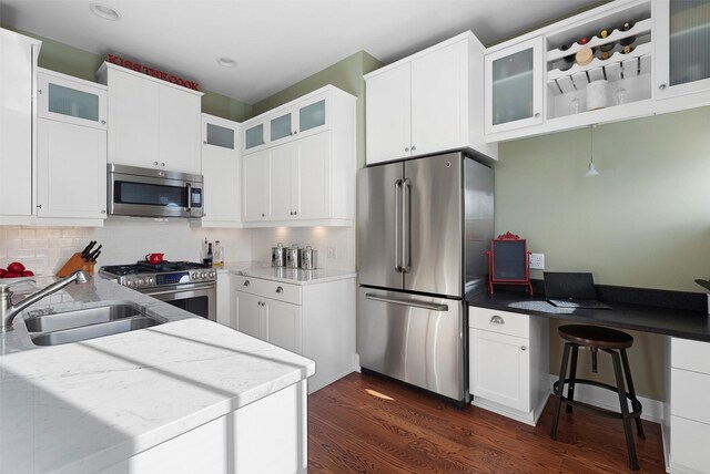 432 W Spruce St Unit 202, Missoula, MT 59802 - kitchen featuring stainless steel appliances, a sink, dark wood finished floors, a peninsula, and white cabinetry