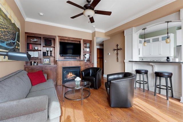 432 W Spruce St Unit 202, Missoula, MT 59802 - living area featuring a ceiling fan, light wood-type flooring, a glass covered fireplace, and crown molding