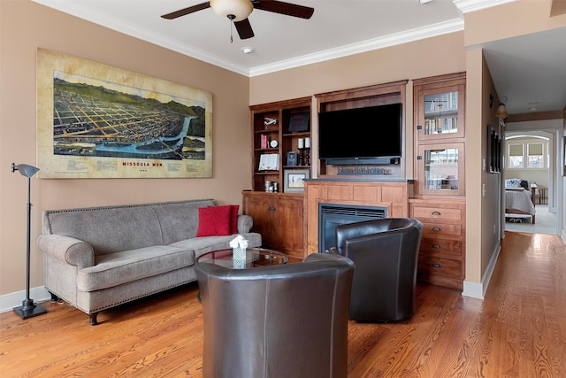 432 W Spruce St Unit 202, Missoula, MT 59802 - living area with a fireplace, a ceiling fan, light wood finished floors, crown molding, and baseboards