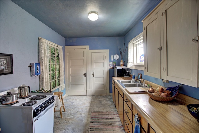 110 N 2nd Ave, Hot Springs, MT 59845 - kitchen featuring electric stove, a sink, healthy amount of natural light, and concrete floors
