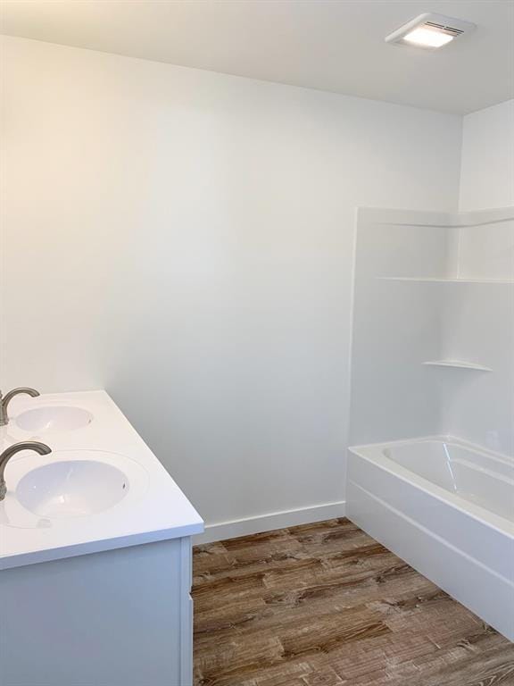 998 Mount Silcox Dr, Thompson Falls, MT 59873 - bathroom with double vanity, wood finished floors, shower / tub combination, and baseboards