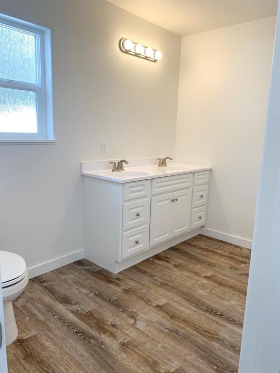 998 Mount Silcox Dr, Thompson Falls, MT 59873 - bathroom featuring double vanity and wood finished floors