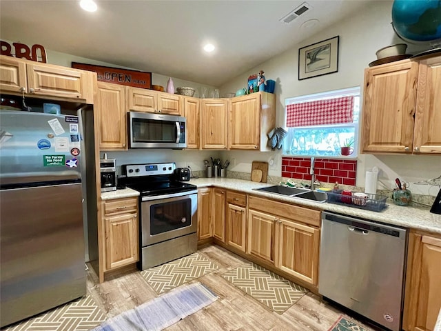 998 Mount Silcox Dr, Thompson Falls, MT 59873 - kitchen with stainless steel appliances, a sink, light countertops, lofted ceiling, and recessed lighting