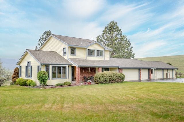 5190 Goodan Ln, Missoula, MT 59808 - traditional-style home with an attached garage, driveway, a front lawn, roof with shingles, and brick siding