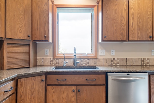 5190 Goodan Ln, Missoula, MT 59808 - kitchen with dishwasher, a sink, and brown cabinetry