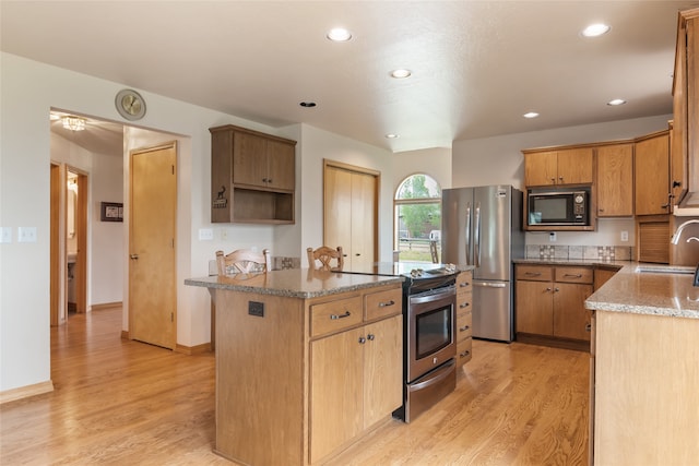 5190 Goodan Ln, Missoula, MT 59808 - kitchen featuring stainless steel appliances, a sink, stone countertops, light wood-style floors, and recessed lighting