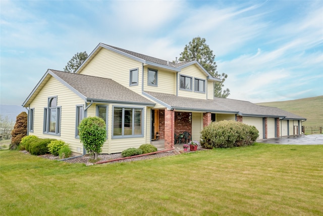 5190 Goodan Ln, Missoula, MT 59808 - traditional-style house with a garage, a front yard, roof with shingles, and asphalt driveway