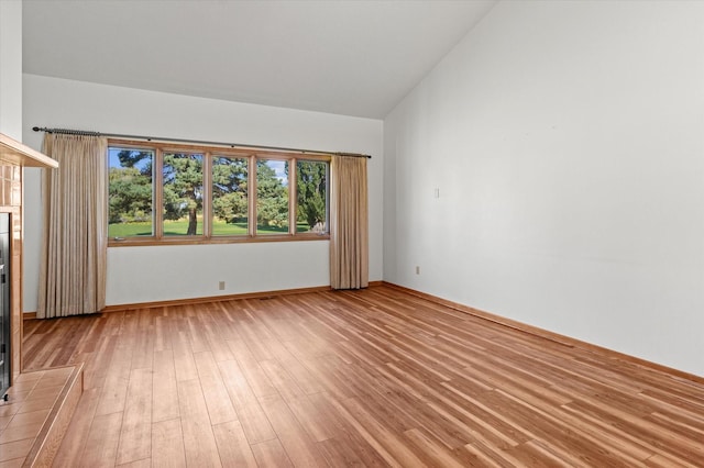 127 Fairway Blvd, Kalispell, MT 59901 - empty room with vaulted ceiling, light wood-style flooring, and baseboards