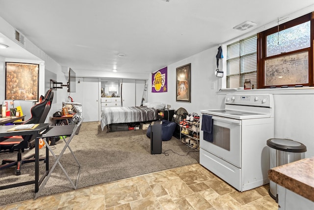 kitchen featuring white electric range, open floor plan, and light stone finish floors