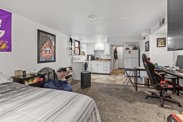 carpeted bedroom with freestanding refrigerator, wet bar, and a desk
