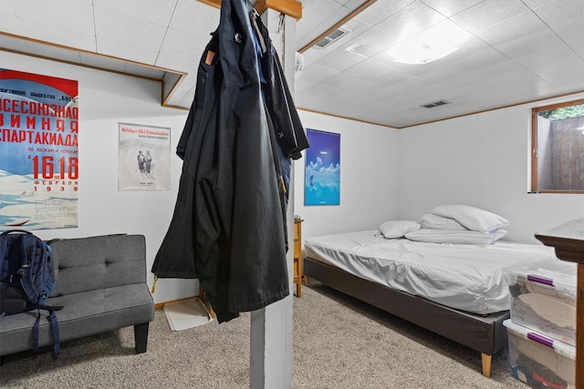 bedroom featuring carpet flooring and a drop ceiling