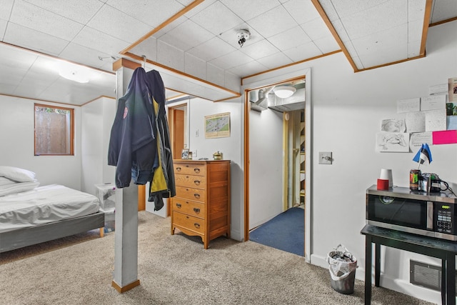 carpeted bedroom with a paneled ceiling
