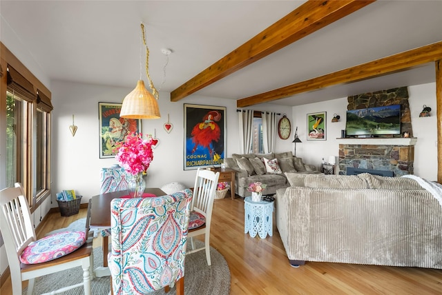15222 Mt Highway 35, Bigfork, MT 59911 - living area featuring wood finished floors, beamed ceiling, and a fireplace