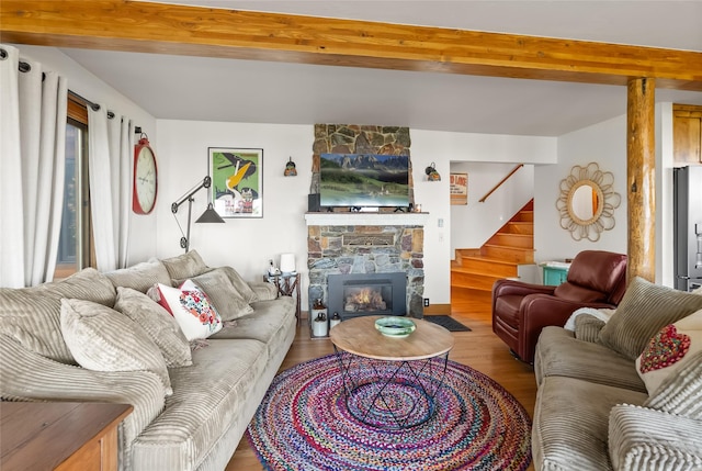 15222 Mt Highway 35, Bigfork, MT 59911 - living area with beam ceiling, stairway, wood finished floors, and a fireplace