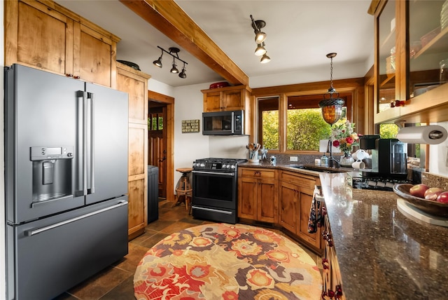 15222 Mt Highway 35, Bigfork, MT 59911 - kitchen with appliances with stainless steel finishes, a sink, brown cabinetry, decorative light fixtures, and glass insert cabinets