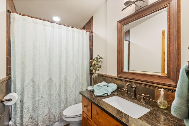 15222 Mt Highway 35, Bigfork, MT 59911 - full bathroom with toilet, vanity, a wainscoted wall, a shower with curtain, and tile walls