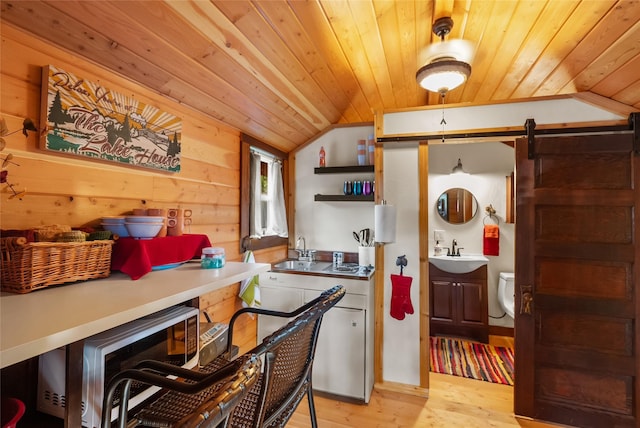 15222 Mt Highway 35, Bigfork, MT 59911 - kitchen featuring a sink, wood ceiling, lofted ceiling, a barn door, and open shelves