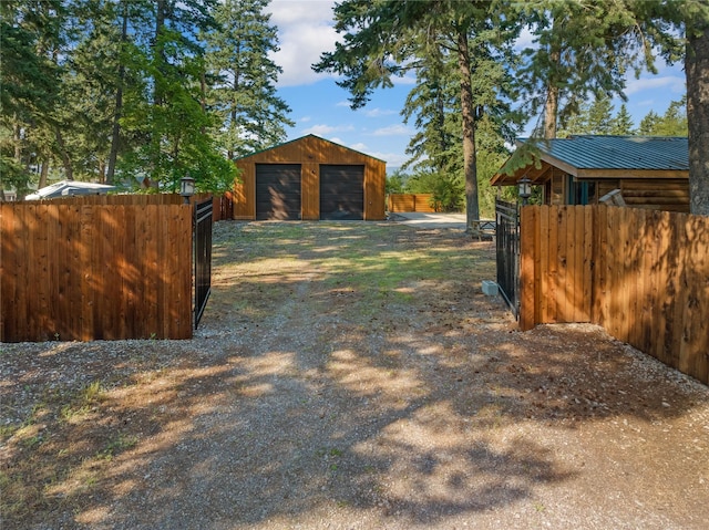 15222 Mt Highway 35, Bigfork, MT 59911 - view of yard featuring a detached garage, an outdoor structure, and fence