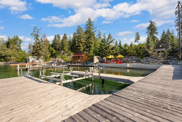 15222 Mt Highway 35, Bigfork, MT 59911 - dock with boat lift, a water view, and view of scattered trees