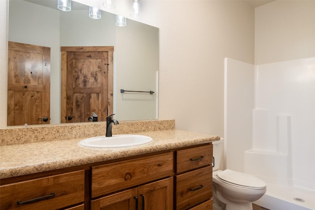 full bathroom with toilet, a stall shower, and vanity