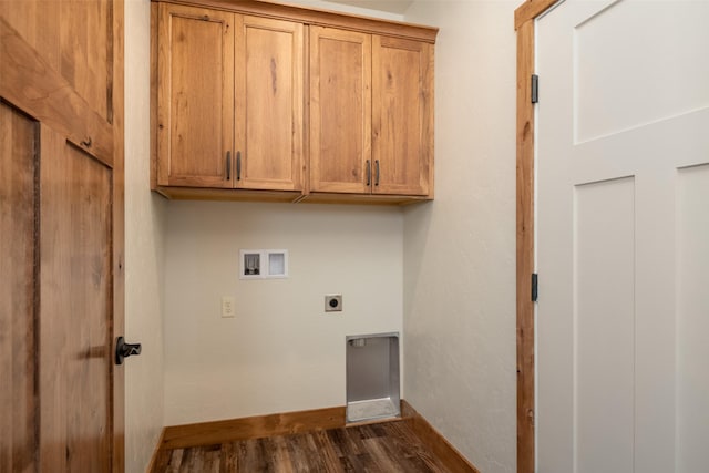 clothes washing area featuring hookup for a washing machine, hookup for an electric dryer, dark wood-type flooring, cabinet space, and baseboards