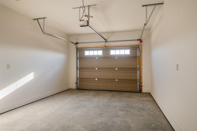 garage featuring a garage door opener and baseboards