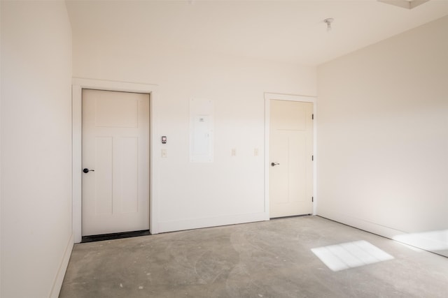 unfurnished room with concrete floors and electric panel