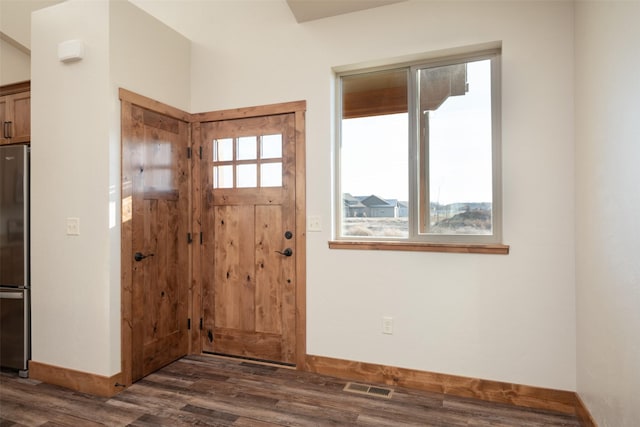 entrance foyer with dark wood finished floors and baseboards