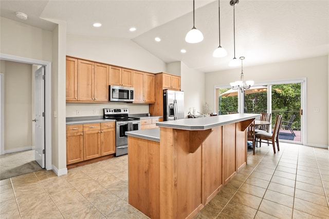 2719 Carnoustie Way, Missoula, MT 59808 - kitchen featuring stainless steel appliances, a chandelier, vaulted ceiling, a center island, and a kitchen breakfast bar