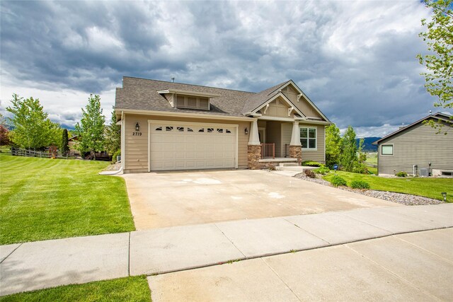 2719 Carnoustie Way, Missoula, MT 59808 - craftsman-style house with a front yard, concrete driveway, a shingled roof, and a garage