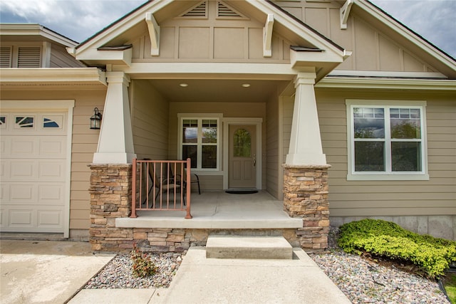 2719 Carnoustie Way, Missoula, MT 59808 - view of exterior entry featuring board and batten siding, covered porch, a garage, and stone siding
