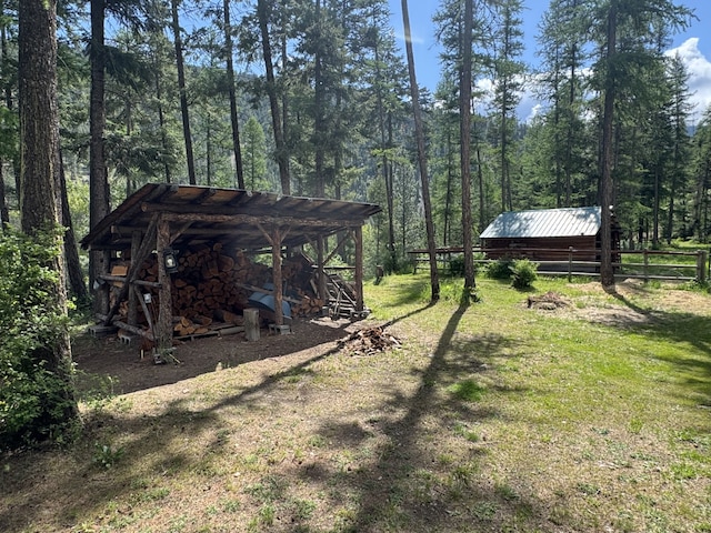 2041 Petty Creek Rd, Alberton, MT 59820 - view of yard featuring a view of trees, an outdoor structure, and an outbuilding