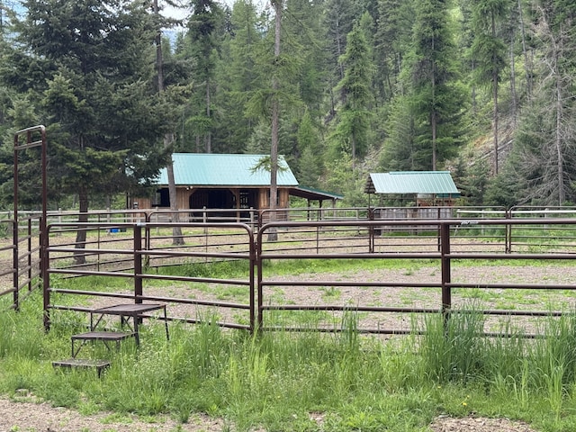 2041 Petty Creek Rd, Alberton, MT 59820 - view of yard with an exterior structure, a wooded view, and an outbuilding