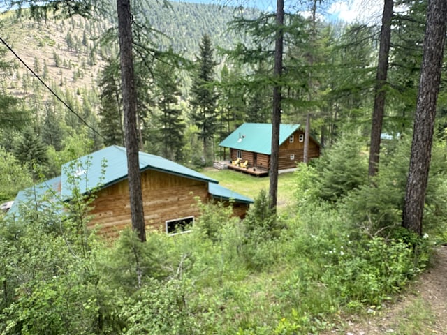2041 Petty Creek Rd, Alberton, MT 59820 - view of property exterior featuring a forest view, an outbuilding, and a mountain view