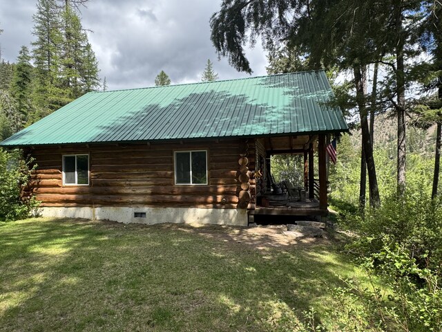 2041 Petty Creek Rd, Alberton, MT 59820 - rear view of house featuring log exterior, a lawn, and metal roof